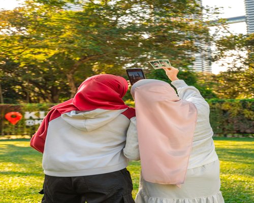 Person holding a smartphone outdoors